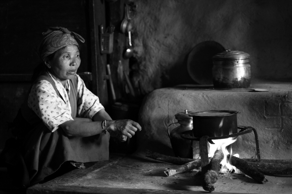 Preparing tea for the family: Yak butter tea is a special Tibetan tradition, so the whole family sits in their one-room house awaiting this unique treat. 