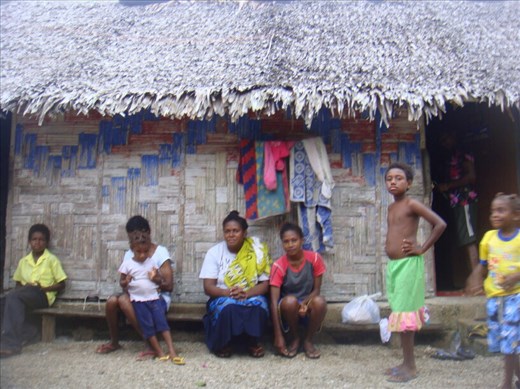 Girls of the family sitting in front of the house, Northeast Malekula.