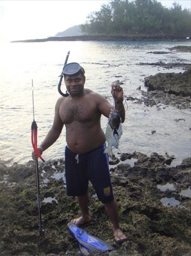Chanel (my adoptive father) having caught his first fish with his new speargun, Caroline Bay, Malekula.