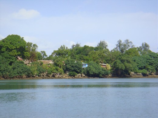 Houses on a precipice overlooking the bay, Caroline Bay, Malekula.