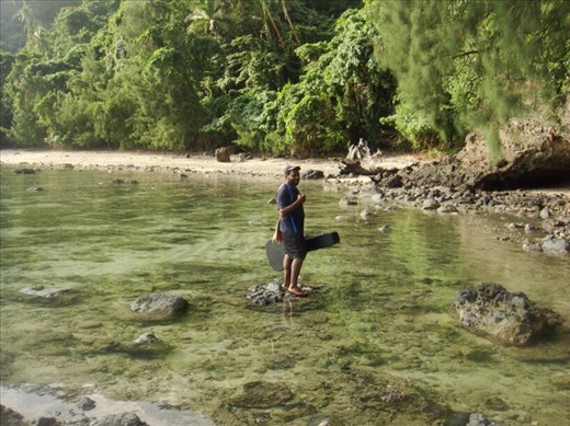 Chanel carrying a guitar over the reef, Malekula.