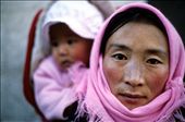 A Tibetan woman with her baby wrapped up on her back circumambulating the Jokhang Monastery, Lhasa, Tibet. For Tibetans bearing a child is an act of conscious intention that involves seven distinct stages - and starts before conception.: by tibetya, Views[812]