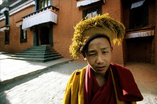 The Tashilhunpo Monastery is one of the main centers of the Gelugpa or Yellow Hat order of Tibetan Buddhism. This is a young monk in his ceremonial yellow hat. Tashilhunpo, Shigatse, Tibet.