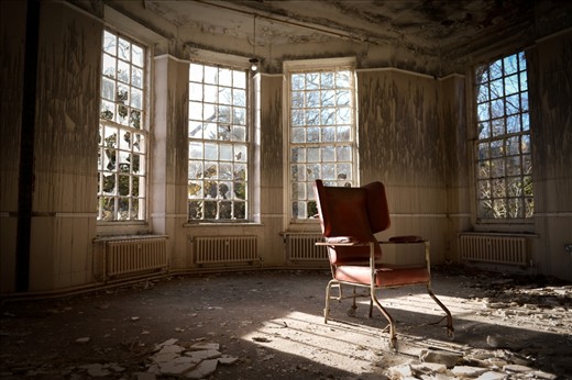 Left behind, a patients day chair has it's first taste of sunlight after a cold November night all alone in the Asylums main hall. 