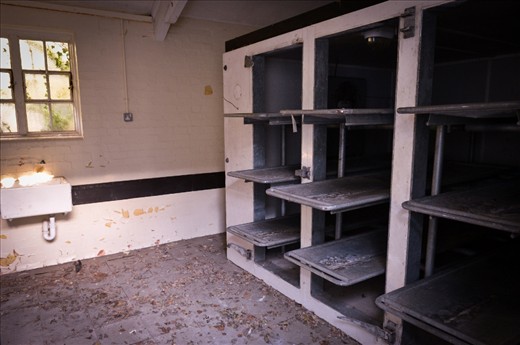 After a long search we come across a crucifix shaped building. Through long dark corridors we come to some large metal doors. 'MORTUARY' stamped into a metal plaque. Easing them aside we are confronted with nine slabs where the unlucky ones were placed.