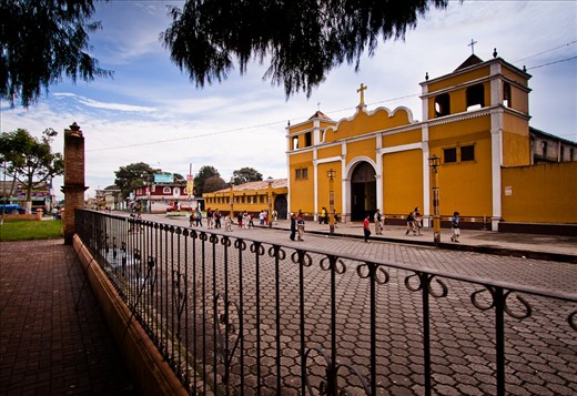 This photograph shows students walking to school while crossing in front of the town's Catholic Church. The Valley of the Pines school was founded and originally managed by the Catholic Church, but is now reliant on the support of donors and volunteers.