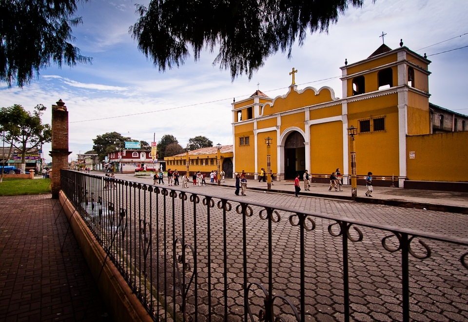 This photograph shows students walking to school while crossing in front of the town's Catholic Church. The Valley of the Pines school was founded and originally managed by the Catholic Church, but is now reliant on the support of donors and volunteers.