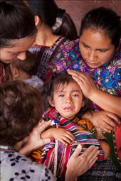 This young girl broke out crying while being treated for a sickness at the medical clinic. Two doctors and the girl's mother were quick to care for the ill child.: by timothybrooks, Views[490]