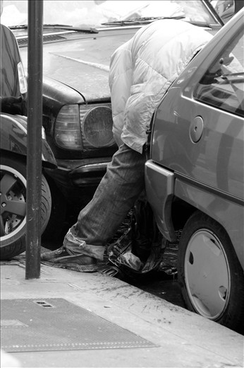 Homeless in Paris. 
A homeless man washes his jeans in the gutter. Homelessness is a major problem in the French Capital and demonstrates the wealth discrepancy present in the city. It was common to see someone sleeping on the footpath, outside designer retail stores.
