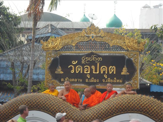 Monks watching the parade at the flower fest in Chiang Mai, Thailand.  I suspect they are masters at reigning in their excitement.