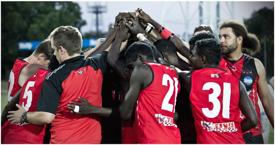 Tiwi Island Bombers share a silent moment in preparation for battle