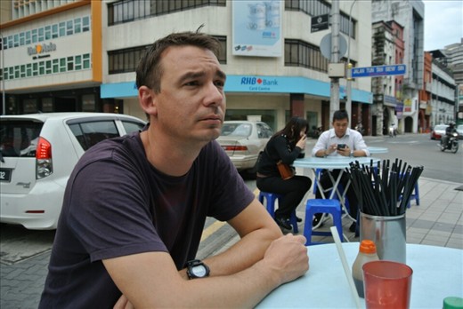 A Chinese man sat at a roadside Chinese restaurant. Oh no, sorry that's Andy!