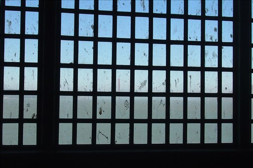 Alcatraz. Freedom. The distant red blur bridge shows through the window bars. 