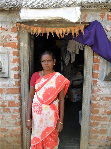 Chitra outside her home