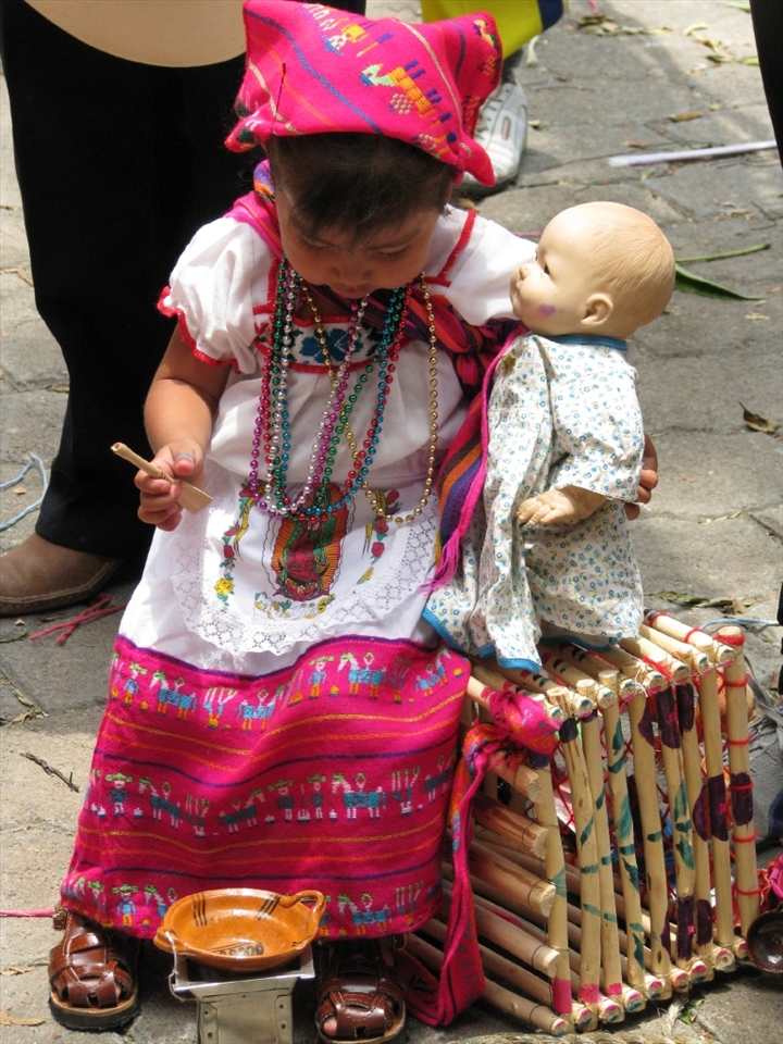 Little girl clad in typical costume for Corpus Chritsti celebration at local church.
