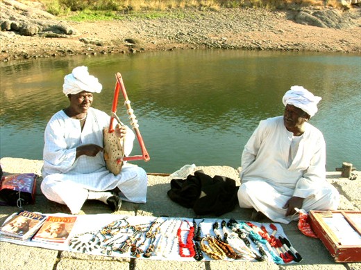 Folklore Instrument 
Music interfere with the locals daily life. this old man promote his goods by playing melodies from heritage using his traditional instrument.   