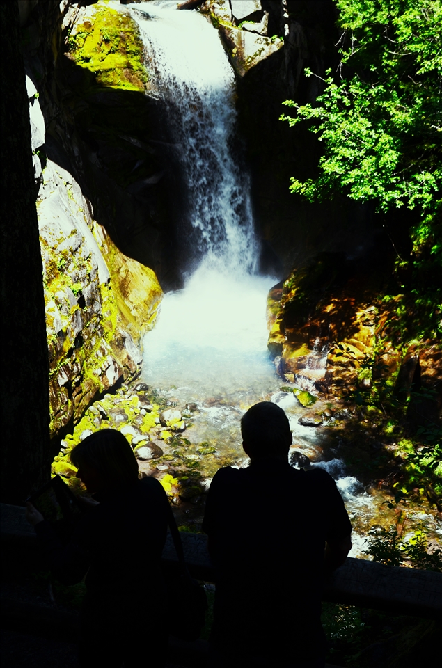 Two people observing a waterfall