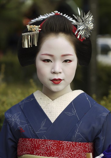 Draped in impossibly elaborate kimono—the most lavish of which can cost upwards of $100,000 USD—and with her face painted porcelain white, catching a glimpse of a maiko as she glides through the worn, well-traveled streets of Gion is akin to gazing upon not a flesh and blood woman, but a ghost. Poised and perfectly put together, geiko and maiko exude elegance and are the living embodiment of centuries of Japanese culture and tradition. So long as they continue to haunt its lanes and alleyways, Gion’s secret histories can endure.