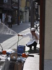 Kyoto, Japan: In the Gion district, a chef washes the pavement in front of his restaurant in preparation for the evening crowds. This age-old tradition continues throughout Japan today, symbolizing that a shop is clean and making it more inviting to passersby. The lazy tranquility that currently enrobes Gion belies the frenetic energy that will soon course down its cobbled lanes, as the neighborhood is one of the few remaining areas where geisha continue to live and work.: by tonykuehn, Views[366]