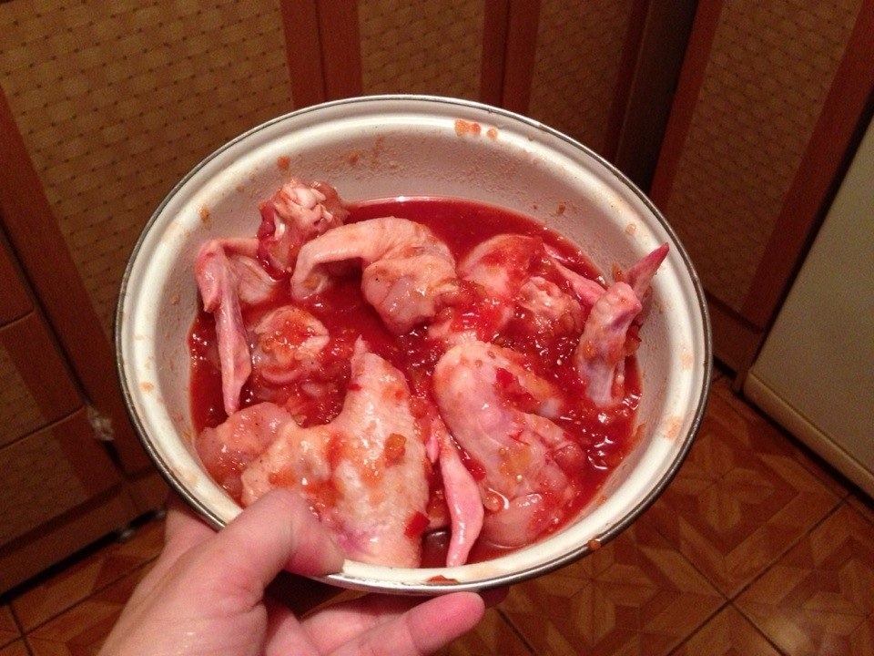 chicken wings are put in sauce