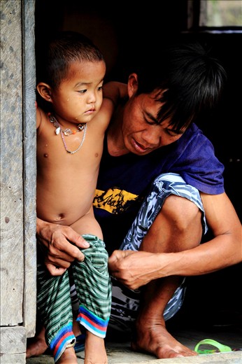 A child is lovingly dressed by her father after a bath