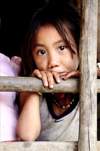 A young girl looks across towards the people bathing