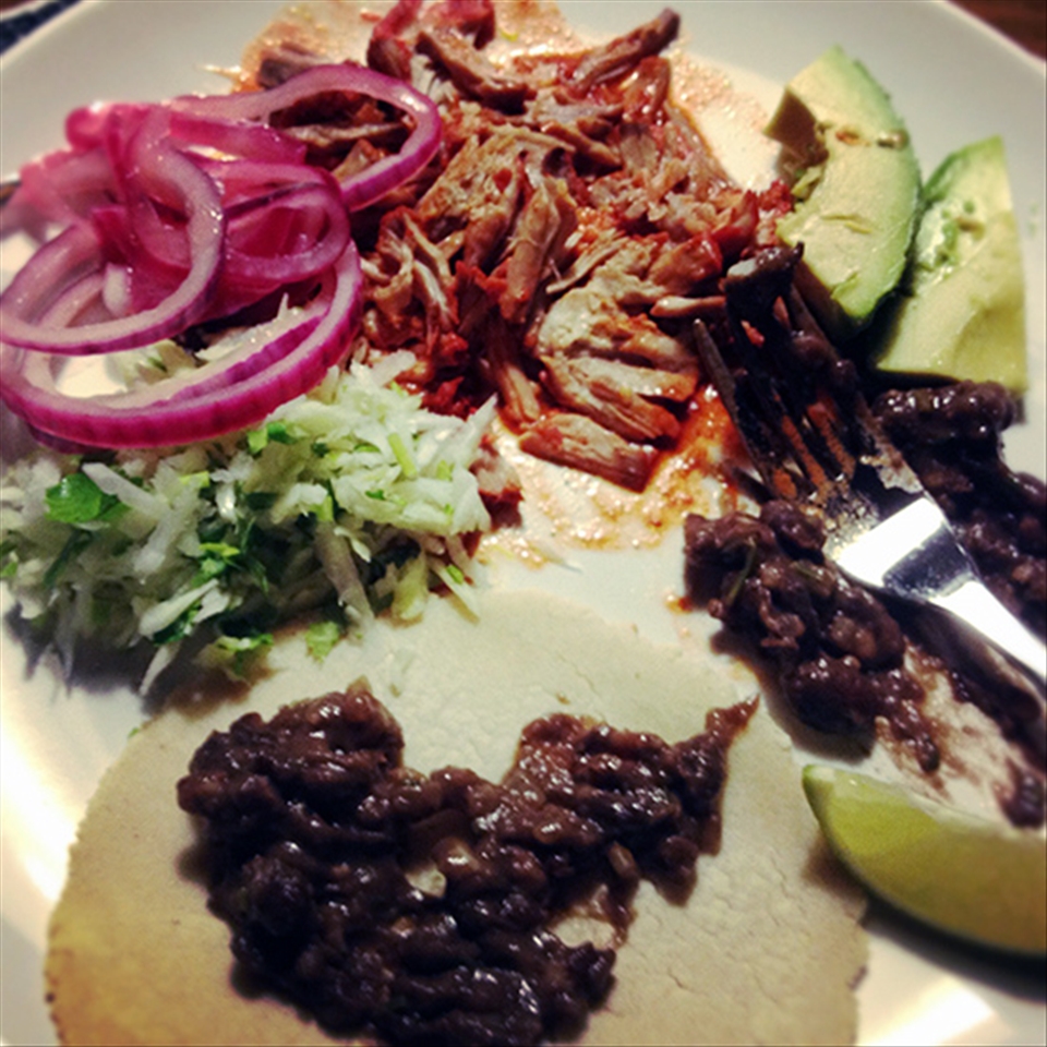 My home made cochinita served with refried beans, salsa and corn tortillas.