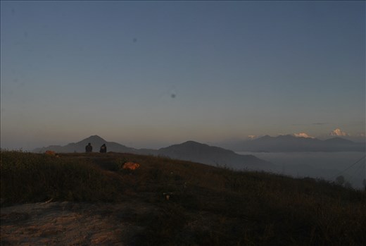 people viewing shining mountains and waiting sun rays to warm up during winter 