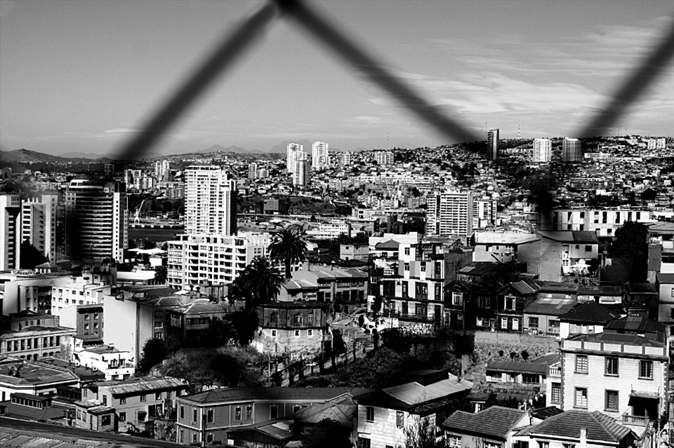 Valparaiso - Chile. 
I took this photo reading an outstanding adventure of Jules Vernes, which reminded  me of the extraordinary sense of freedom and creativity. From this observation point we can discover Valparaiso, city of thousands of colors. However, from a different perspective, here we have Valparaiso in simply in black and white.