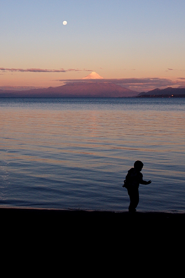 Osorno Volcano – Puerto Varas, Chile. 
The Osorno stands on the East of the Llanquihue Lake as a white pyramid with a mysterious aureole of clouds. A Mapuche legend, an aboriginal community in the South of Chile, says that a malign spirit, El Pillan, is confined in his womb under the ice.