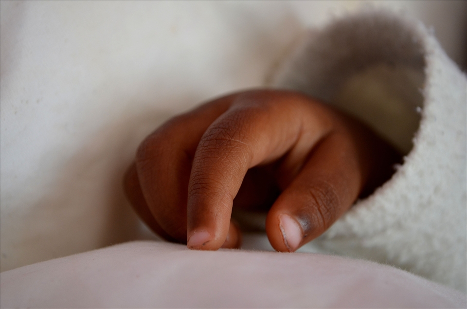 The fragile fingers of an orphan baby