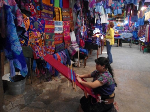 Chamulan in traditional garb hand-making scarf.
