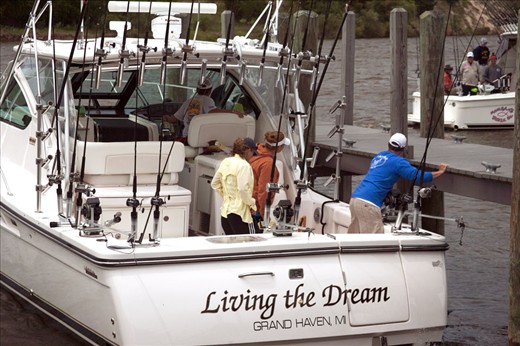 Docking and unloading a cooler filled with fish.