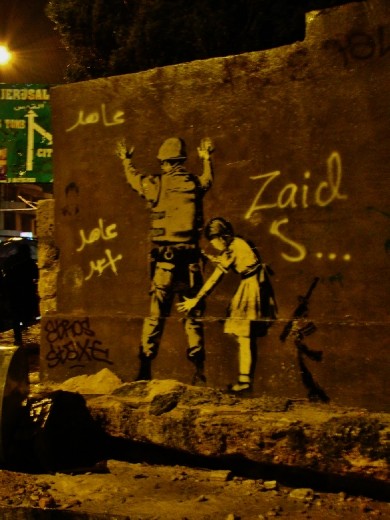 Israel Palestine wall with its graffiti, one of Banksy’s paintings