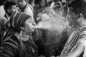 A shaman spits schnapps in the face of a man in a cleansing ritual that also includes being hit by seven different herbs and drinking a shot. Maximon has a weakness for alcohol and so the most common offering is a bottle of schnapps or beer, although money bills and fried chicken are popular alternative.: by troels, Views[2451]