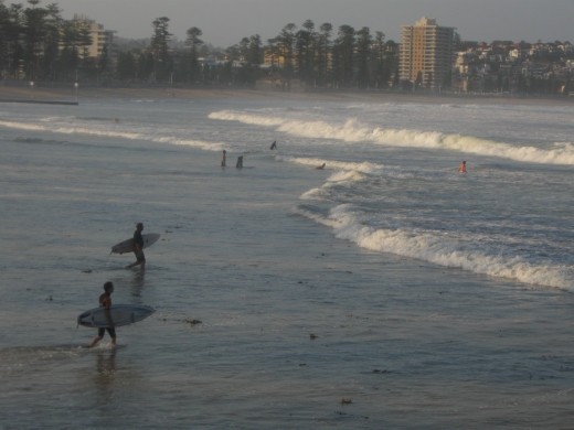 Manly beach has some dedicated surfers who mostly come out around 6ish after work when the sea allows.