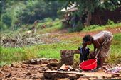 When clean water is so sparse the luxury of washing clothes in clean water is simply not an option.  This lady and her child wash the family clothes at the village water supply.: by uganda, Views[1315]