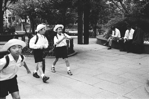 One day these carefree, lighthearted children will trade their uniforms for suits; their innocents for the burdens of life.