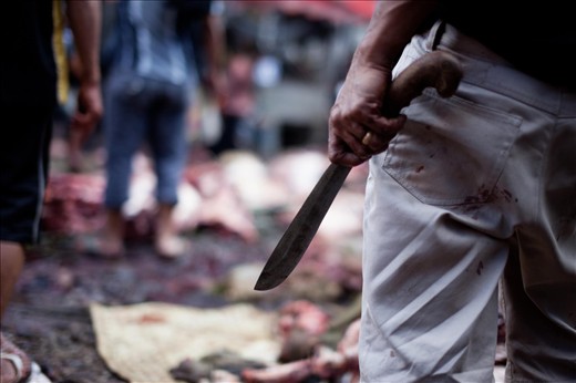 Ceremonial butchers kill the animals in a bloody fashion and cut it up for food