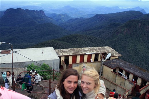 Tourist posing to get a glimpe of the surrounding views from the top of Sri Pada / Adam's Peak Mountain