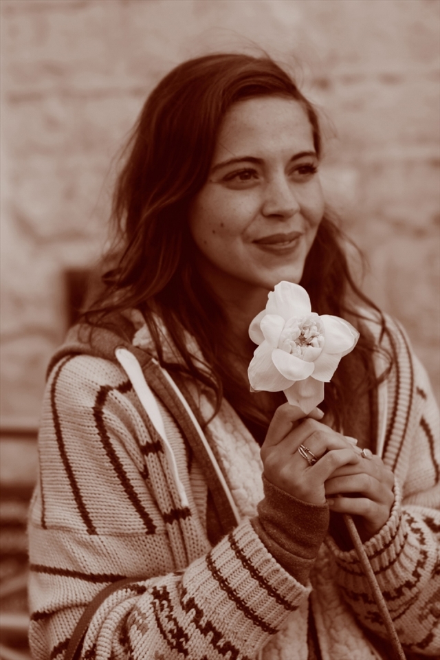 Tourist offering a Lotus flower at the shrine on top of Sri Pada / Adam's Peak Mountain.