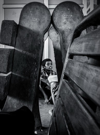 This boy represent all the boys who lives at the station and make there living out of the rages-water bottles, contains, papers- thrown by the passengers on to the platform or on the railway tracks. They risk there lives to collect the waste from the tracks, so that they can sell it and  earn something out of it. Usually whole family is involves in this task. Many a times members from different families fight over the collect just a simple plastic bottle thrown by the passenger. This boy was having some quite time sitting with his mates after collecting some plastic bottles.