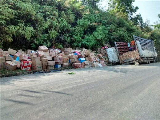 Truck in the gutter, boxes all over the road, oh my!