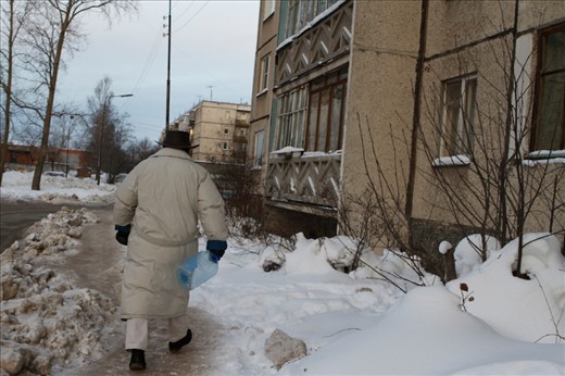 The daily routine of a man who is on his way to collect water with his empty bottle. 