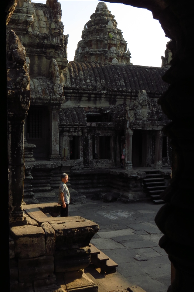 A man peacefully contemplates a temple at Angkor Wat  in Cambodia.