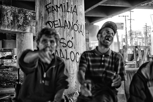 Under the same bridge, many stay the whole day sitting on a sofa drinking pinga.