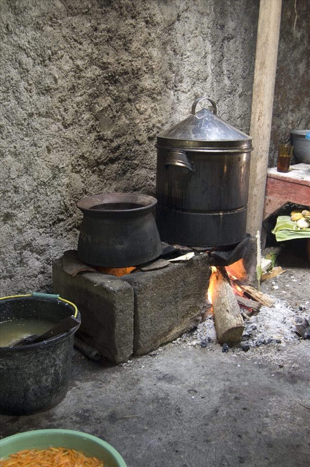 2. Close to the ground the meal is boiling on a natural stone set, the fire is crackling and the Javanese wedding is soon to be started. Taken in Tawangsari, Jawa Tengah, Indonesia, january of 2012. Technical equipment: Nikon D50, lens AF-S DX NIKKOR ED 18-55mm 1:3.5-5.6G, auto exposure
