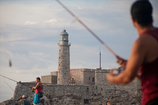 Fishermen in the Malecon in front of the lighthouse in Havana, Cuba
