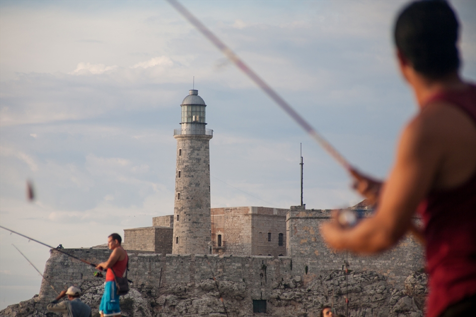 Fishermen in the Malecon in front of the lighthouse in Havana, Cuba