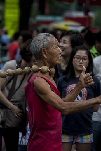 That is a Huge Necklace of the Street performer in Singapore